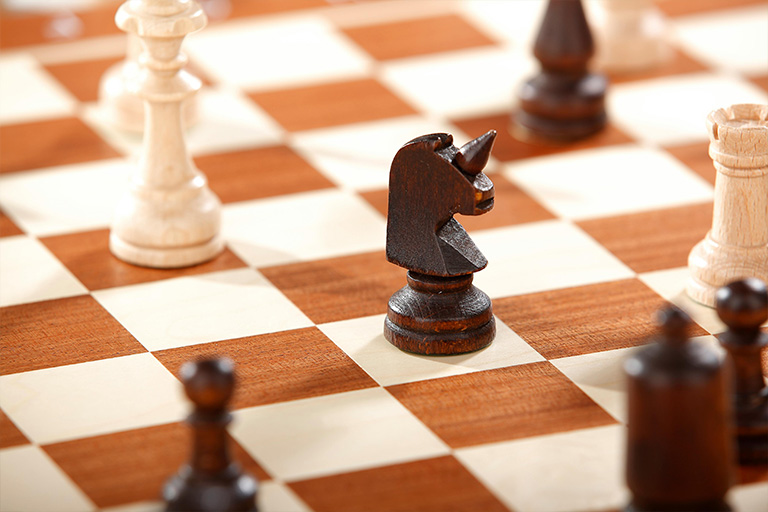 Picture of chess pieces on a chessboard.
