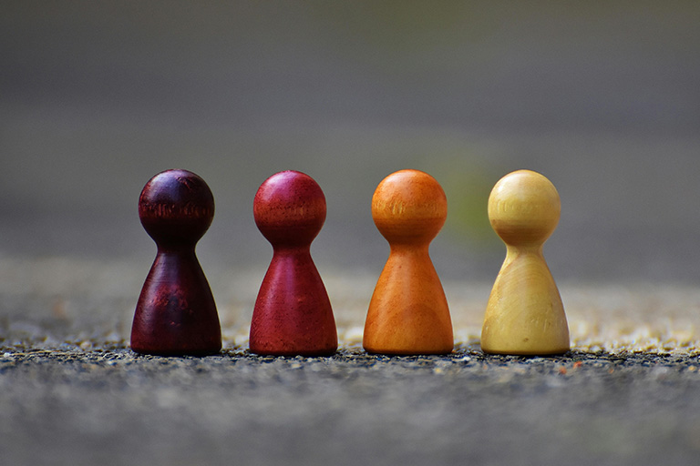 Picture of four differently colored boardgame pawns.